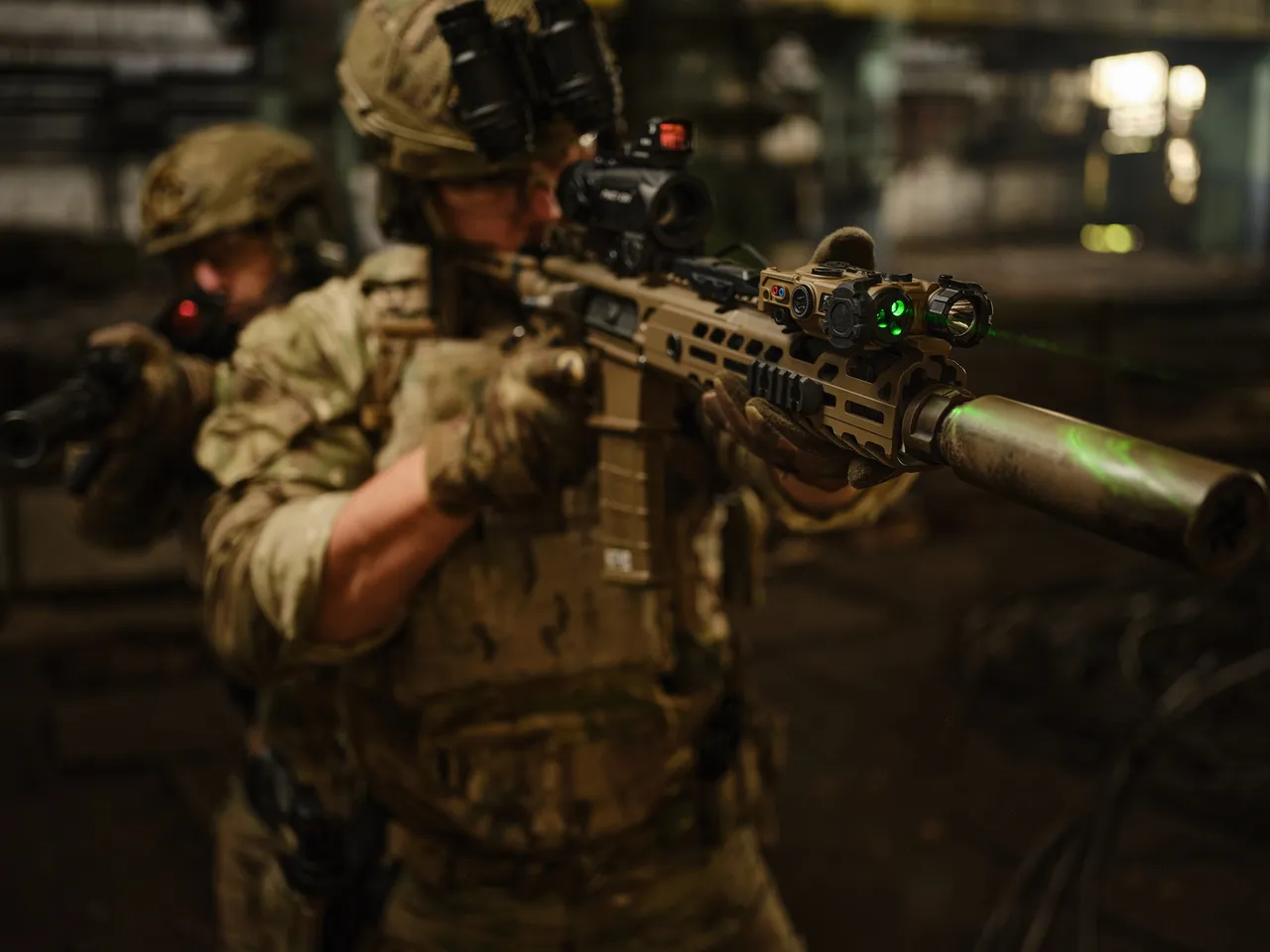3E promotional image showing operators with night vision and optical equipment advancing in low light
