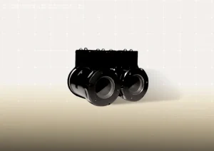 Beyaz fon önünde siyah renkli, iki paralel silindirik gövdeli ve üstte vida başlıklı bağlantı elemanları bulunan bir solenoid valfin önden çekilmiş fotoğrafı