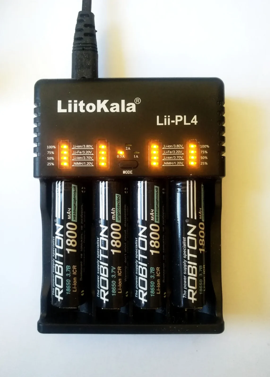 Four 18650 lithium-ion cells in a charger