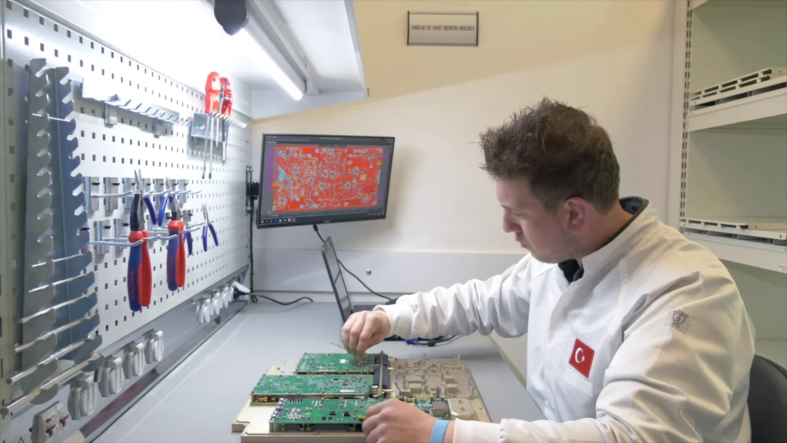 Technician working at a CTech cabling and board assembly station