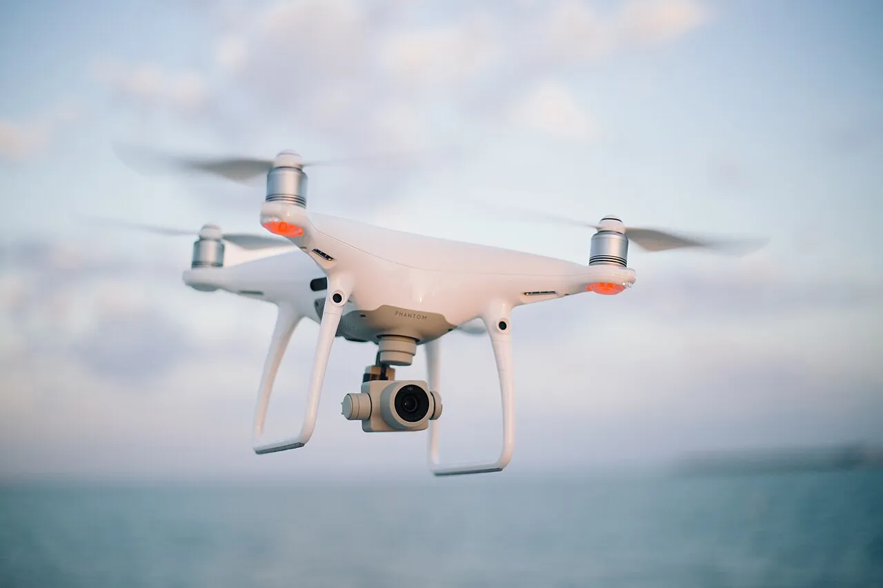 Four-rotor camera drone in flight